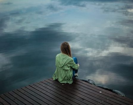 Picture of woman looking out across water